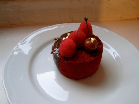 This pastry was called an Osiris. I bought it for the name. It turned out to be chocolate mousse with raspberry jam in the center. Then, one side was glazed with chocolate, and the other was dusted with colored powdered sugar. Very tasty.